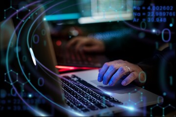 Man working on laptop in dark