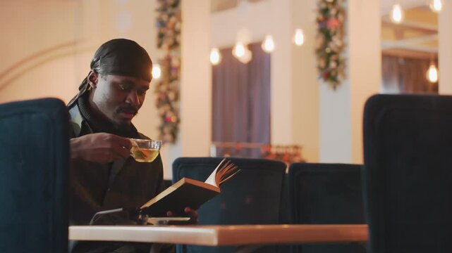 educator finds happiness, educated man experiences pleasure during leisurely discovery at cafe, university scholar finds joy in gentle exploration within peaceful coffee shop environment