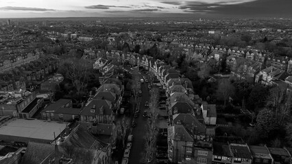 Muswell Hill neighborhood with residential rooftops and bare trees in black and white
