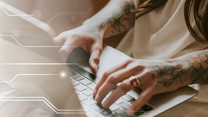 Fototapeta premium Tattooed woman work form home on a sofa