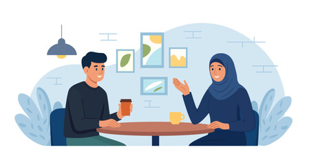 Happy young Muslim couple enjoying hot coffee together at cozy cafe table sharing pleasant and warm conversation. Social interaction and cultural diversity. Romantic meeting in cafeteria