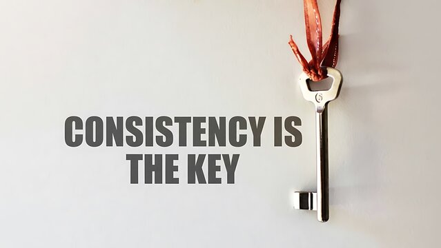 Silver antique key hangs from red ribbon with text 'CONSISTENCY IS THE KEY' on a textured light background, motivational concept - Powered by Adobe