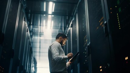 Medium shot featuring an IT expert managing a server room filled with racks for digital document preservation. - Powered by Adobe