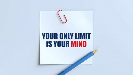 Fototapeta premium White square sticky note with red paperclip and blue pencil attached, displaying motivational quote 'Your Only Limit is Your Mind' in bold blue and red sans-serif font.