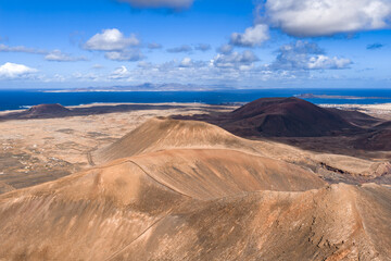 Aerial scene shows Fuerteventura cones and calderas near Caldera Los Arrabales and Playa del Bajo...