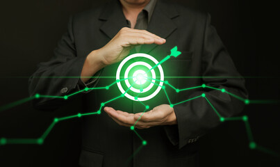Data-driven target and growth concept with businessman holding glowing bullseye, green analytics graphs hitting the center. Business precision, performance, intelligence, focus, objective, strategy.