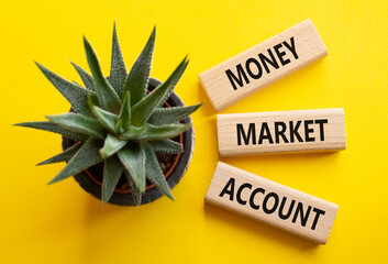 Money Market Account symbol. Wooden blocks with words Money Market Account. Beautiful yellow background with succulent plant. Business concept. Copy space.