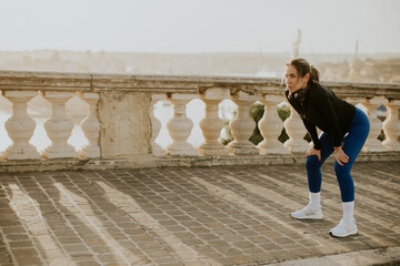 Woman exercises in Malta during the morning with scenic view in the background