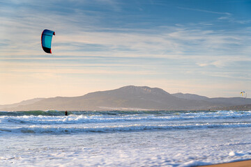 Kitesurfer with kite against sky at sunset on coast famous surf spot in Spain, Tarifa, Atlantic Ocean. © Tomasz