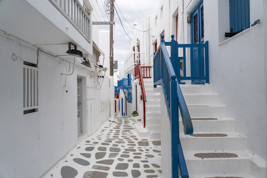 View of the iconic whitewashed buildings and cobblestone paths create a mesmerizing labyrinth, blending architectural charm, Old town, Mykonos, Greece.