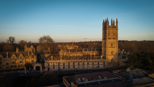 OXFORD, UK - JANUARY 10, 2026 - Magdalen College Tower and historic university buildings bathed in warm light under a clear sky