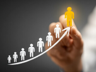 Business concept of success and leadership growth with ascending line of human icons and hand pointing to highlighted person at the peak of progress graph