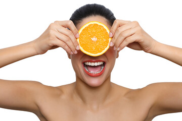 Woman holding orange slice over eyes laughing
