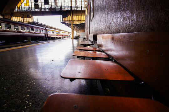 Empty wooden benches in a spacious old-fashioned train station