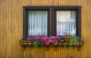 Charming Country House, Village Style Residence Showcasing Vibrant Floral Window Box And Vintage Siding