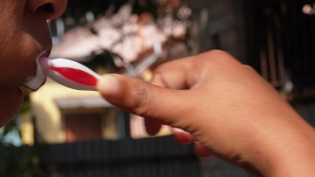 Person brushing teeth with toothbrush