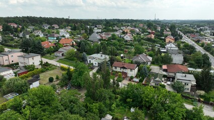 Fototapeta premium Aerial Panorama of Suburban Houses and Green Landscape