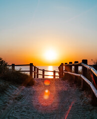 Fototapeta premium Sunset over the Baltic Sea seen from a wooden boardwalk in Latvia