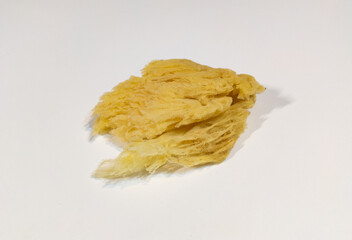 Natural yellow sea sponge isolated on white background. Natural, organic cleaning and bath concept.