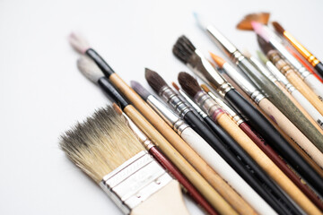 Watercolor brushes set isolated on white background, art supplies collection for painting, different sizes and shapes. Back to school.