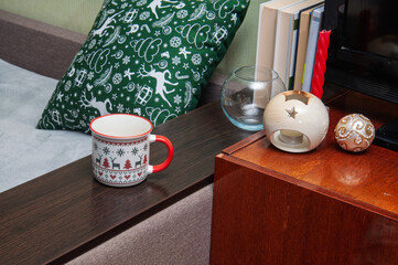 Cozy Christmas morning scene with festive mug and holiday decor on a wooden table