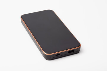 Sleek black portable power bank with rose gold trim on a white background