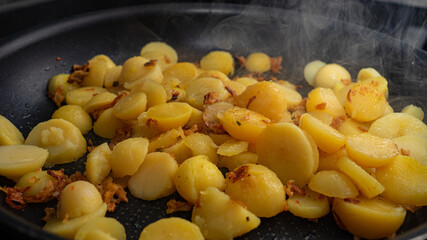Crispy fried potatoes with onions in the pan