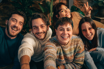 Happy group of friends smiling together at home - friendship, connection and positive emotions.
