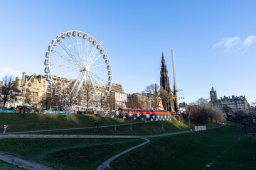 Ferris Wheel and Gothic Spire in Cityscape  in Edinburgh, Scotland.