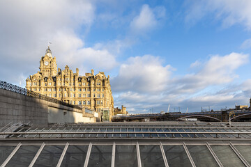 Historic Building and Glass Roofs Under a Cloudy Sky  in Edinburgh, Scotland.