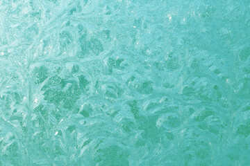 Beautiful winter background with frosty pattern on glass