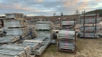 Construction scaffolding and pipes stacked outdoors