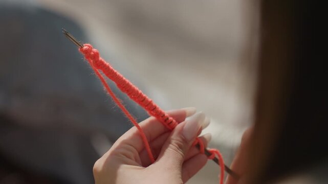 close view of stitching ambiance, detailed focus on looping stitches within cozy setting described, precise depiction of craftsmanship emphasizing looping patterns in snug environment