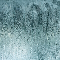 Abstract background with frozen foggy glass and wet water stains