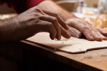 The master cycles the surface of the tagelharpa soundboard with glass