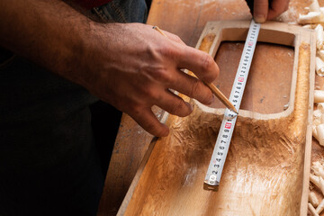 The master marks the talharps on the soundboard with a pencil