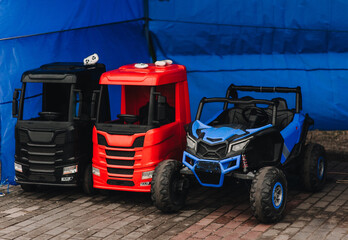 A photograph of many colorful children's plastic cars parked in a rental park.