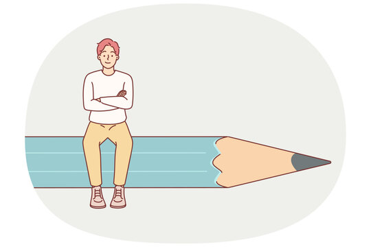 Man designer sits on giant pencil and crosses arms in front of chest, demonstrating confidence