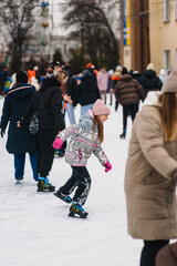 Beautiful happy smiling teenage girl, child skating on ice rink in winter outdoors.