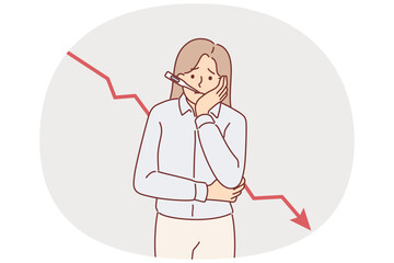 Woman entrepreneur is experiencing problems in business, standing near falling chart