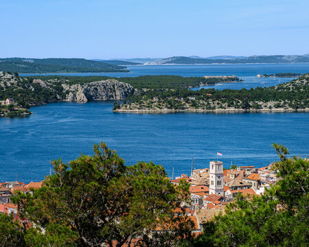 A high-angle view overlooking the red roofs of &Scaron;ibenik town, the blue bay, and the many islands of the Dalmatian coast