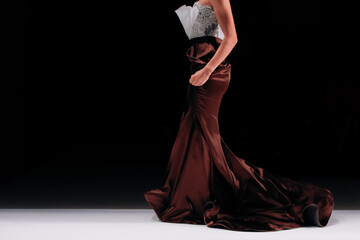 Chic elegant satin brown skirt and white blouse, fashion woman's luxury outfit on black background