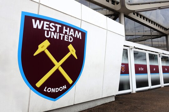 The emblem of the English Premier League club West Ham United is displayed on a wall at the London Stadium, located in London, United Kingdom