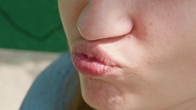 caucasian woman smiling freely outdoors, closeup of cheerful female enjoying outdoor sunlight, casual image capturing playful caucasian woman with cheerful expression outside in sunlight
