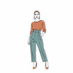 Stylish woman orange top teal pants posing