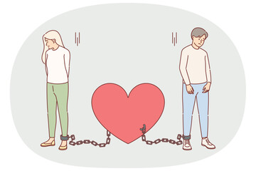 Shackled couple in love suffers from lack personal freedom, stands tied with chains to heart