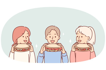 Little children eat sandwiches, satisfying hunger with delicious snack bought at fast food cafe