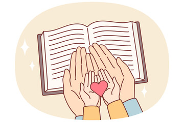 Hands of child and mother over bible with christian prayers, as metaphor for religious education