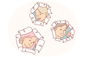 Happy schoolgirls make surprise by peeking out of holes in papers and peeking at you with curiosity