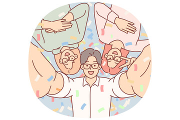 Cheerful friends take selfie together at party in nightclub, posing among falling confetti